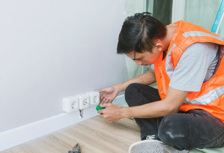 canva man installing electrical sockets in a residential unit MAEhtWMYQQ